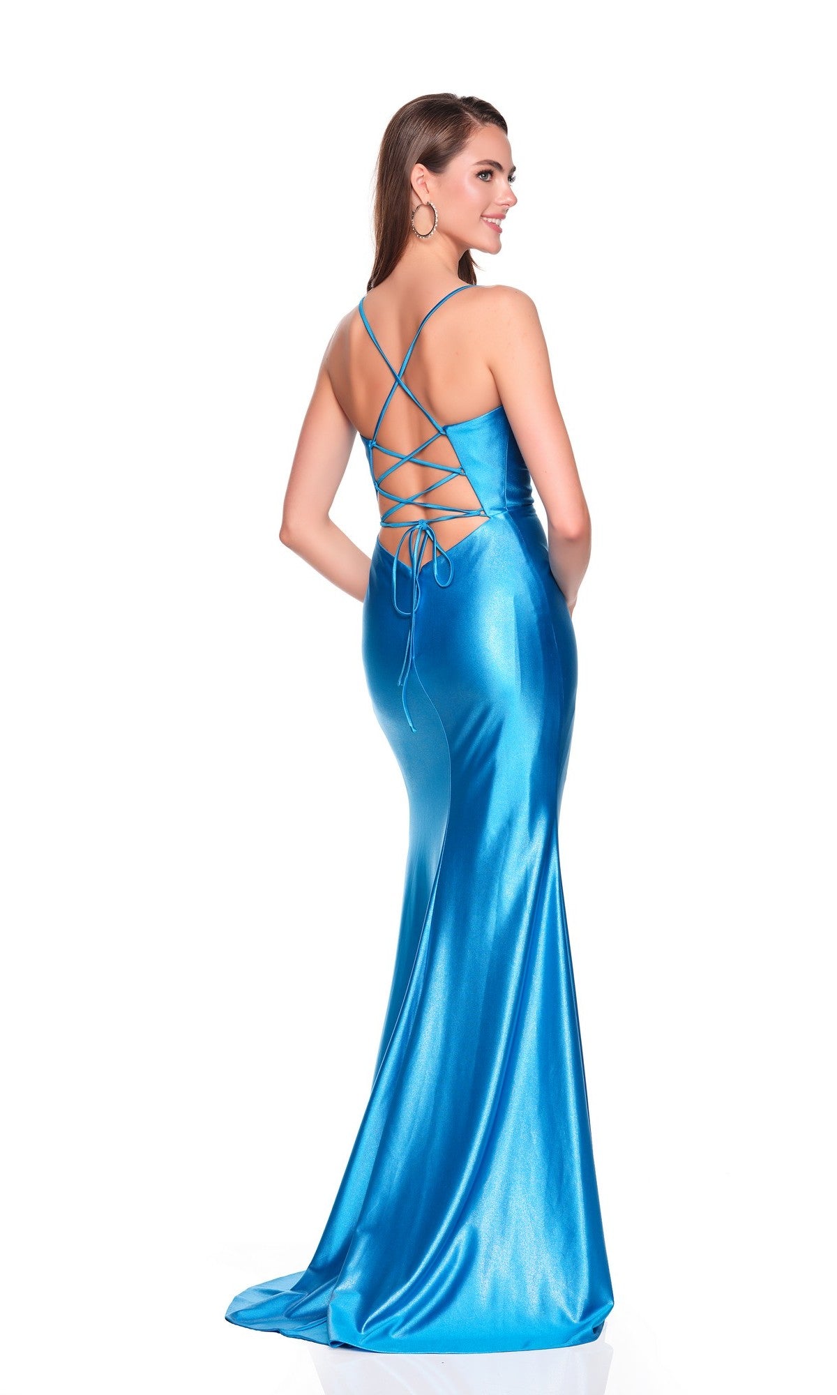 A woman poses and smiles over her shoulder in the Long Prom Dress: Dave and Johnny 12672, a shiny satin blue gown with a lace-up open back, against a white background.